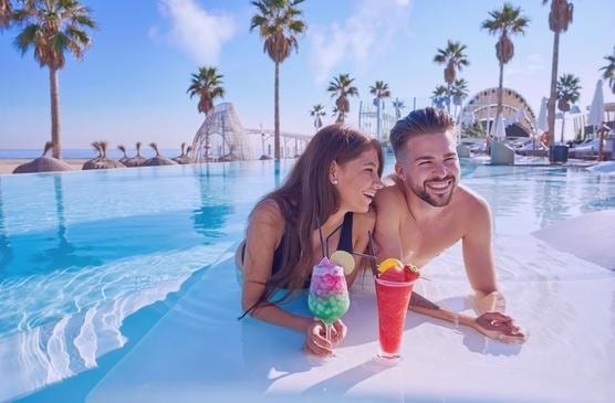 All-inclusive beach resort couple relaxing